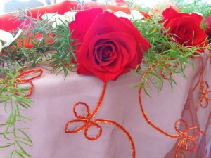 Red rose and tablecloth close up