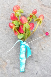 Red and aqua berry boutonniere