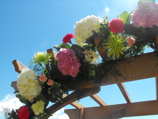 close up pink green floral arch